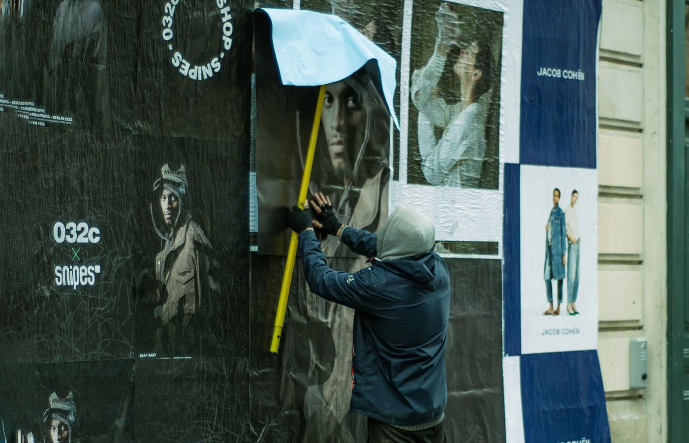 Wheatpaste poster installation by street teams in Miami